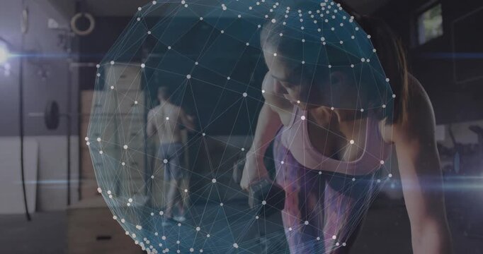 Woman pulling dumbbell in gym, lifting motion starting AR sphere displaying metrics, man moving