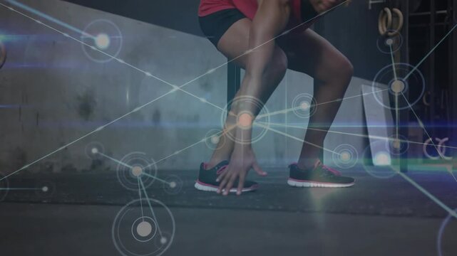 Approaching camera woman wearing red top, training lateral footwork at gym rig, overlay tracking