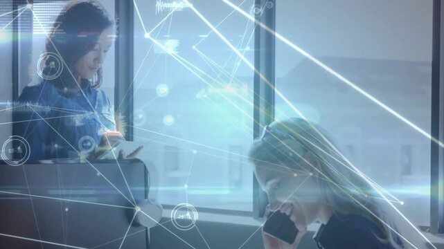 Vertical video: Call starting as two women phoning and using tablet, HUD animating teamwork