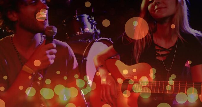 Vertical video: Guitarist strumming, singer with mic, pulling back revealing drums, bokeh for music