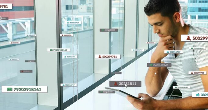 Man tapping tablet at counter by windows, generating animated numeric tags for business