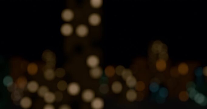 Abstract view of blurred city light from train. Defocused building lights from moving traffic on a urban night cityscape. Round colorful bokeh effect. 4K 3D rendering loop animation.