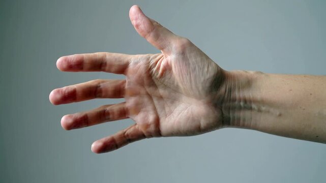 This close-up shot of an outstretched hand evokes a sense of vulnerability and connection. Ideal for illustrating concepts of communication, support, 