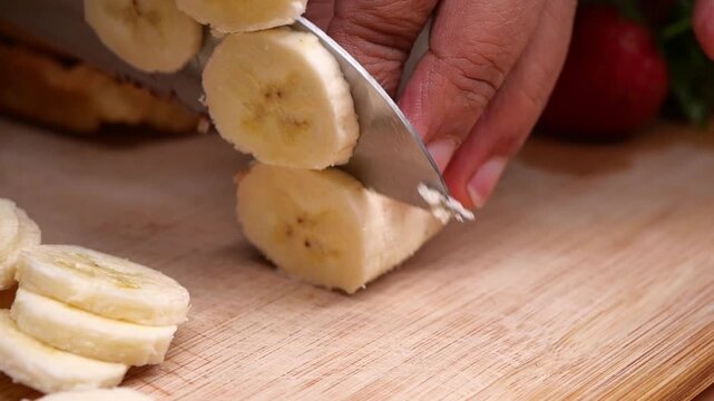 Cutting bananas for a healthy snack in the kitchen