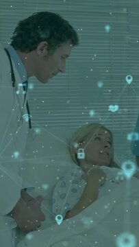 Physician leaning over patient, starting exam and projecting health icons over bed, patient smiling