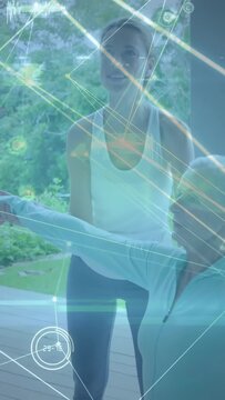 Vertical video: Helper placing hand guiding senior arms upward holo overlays link joints for rehab