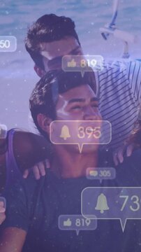 Vertical video: Group by sea laughing as alerts popping over and counts rising, showing media reach