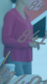 Vertical video: Note-taker writing causing lens shift to lead speaking in business meeting, numbers