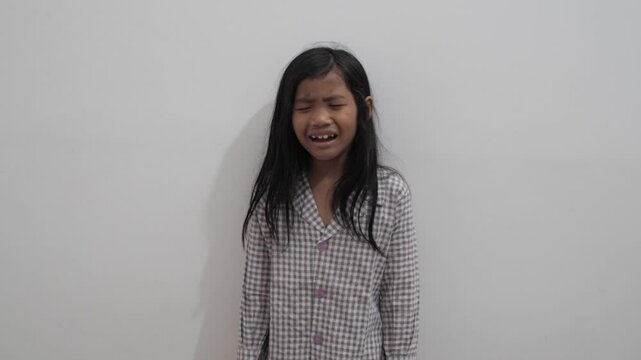 Upset little Asian girl crying with tears on face, sad child feeling disappointed and hurt, childhood bullying, loneliness, and emotional trauma