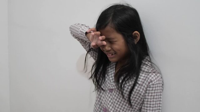 Upset little Asian girl crying with tears on face, sad child feeling disappointed and hurt, childhood bullying, loneliness, and emotional trauma