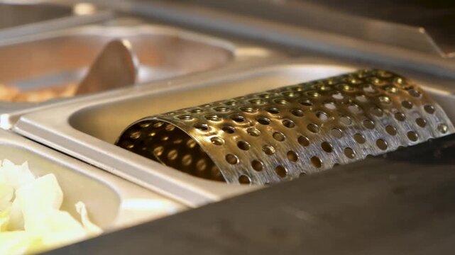 Watch a soft burger bun glide over a butter or oil roller in this short, satisfying clip.