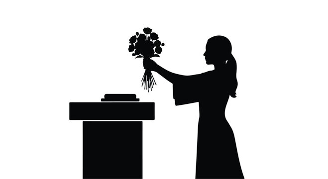Silhouette of a person placing flowers on a monument, honoring memory