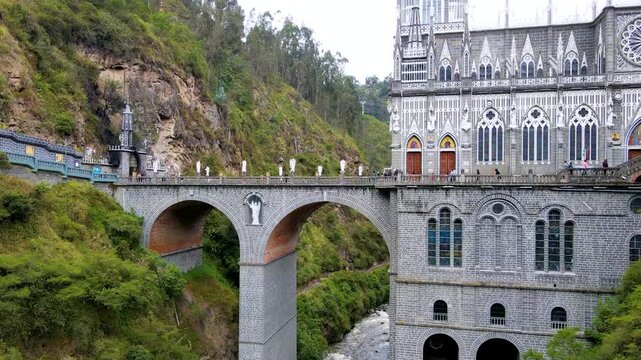 Dramatic cliffs and a striking church intersect with a river below at Santuario de las Lajas in Colombia.