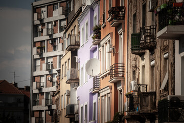 Fototapeta premium Satellite dish mounted on older residential buildings in Belgrade old town, Stari Grad, Serbia. The scene shows layered facades, balconies and urban housing details in a dense historic neighborhood.