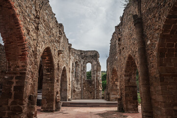 Fototapeta premium The ruins of the Old Saint-Pons Church, Ancienne Eglise Saint-Pons, in Collobrieres, France, showing stone arches, weathered walls and the open interior of the abandoned monument in Provence.