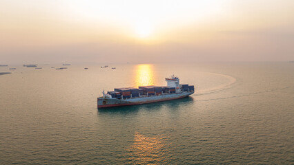 Fototapeta premium Large container ship loaded with cargo navigating the calm sea at sunset. Global trade logistics, maritime commercial freight transport, and energy commodity supply chain concept.