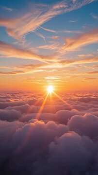 sunset over clouds above horizon with sun rays and orange blue sky