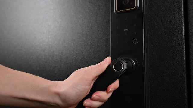 A woman opens a modern smart door lock with a digital keypad and biometric fingerprint access.