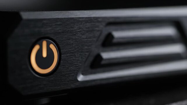 Glowing power button on black electronic device