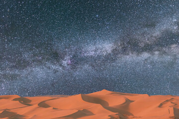milky way and milky way over the desert in the night. the stars in the middle.