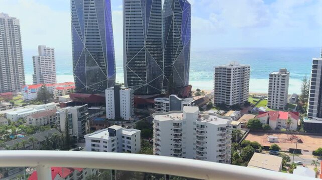 Sweeping balcony view over the glittering Gold Coast, Queensland &ndash; from golden beaches to city skyline in one smooth, sun‑soaked pan.