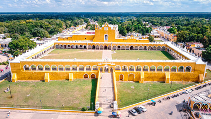 Golden colonial complex stands grand under bright sky © ExploringandLiving
