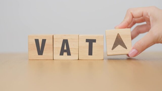 hand change wooden block with VAT text to UP and Down arrow icon. Value Added Tax, decrease and Increase, Taxpayer, Taxable Income, Tax Filing, Deduction, Withholding Tax,  Computation and Exemption