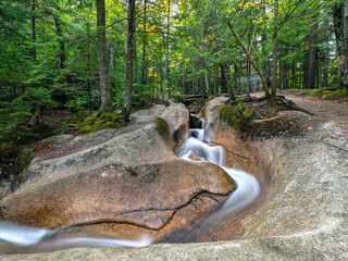 Autumn on the swift river, with waterfalls © John Anderson