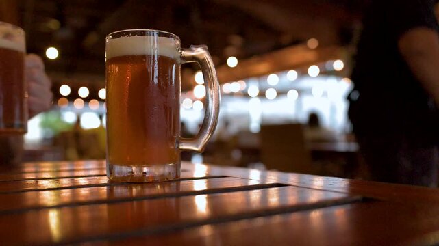 Cold Glass Mugs of Amber Lager Beer on a Wooden Table