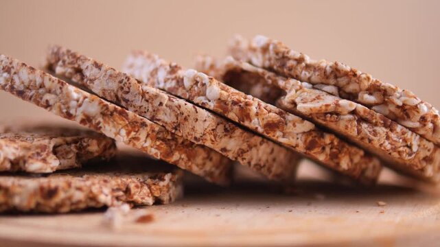Healthy, organic round puffed rice cakes stacked on a wooden plate, offering a nutritious and crunchy snack option for a balanced diet