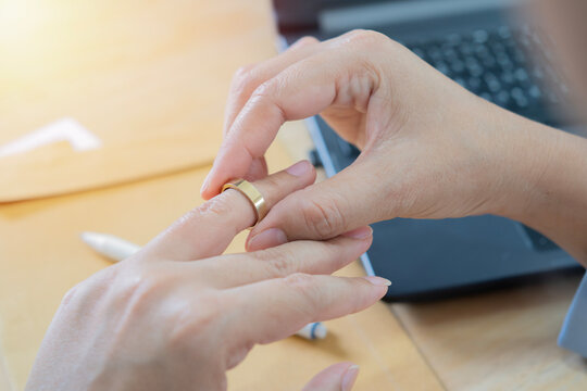 Doubt, stress and hands taking off ring for a divorce after marriage conflict, toxic relationship or cheating