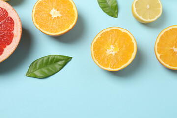 Fototapeta premium Citrus fruits, including grapefruit, lemon, orange. The concept of a source of fresh vitamin C, increasing immunity, removing toxins, natural healthy lifestyle, organic fruits. on a blue background