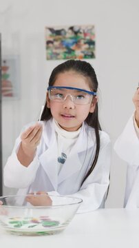 Asian Children in Lab Coats Conducting Science Experiment with Milk and Food Coloring