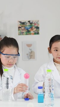 Asian Students Conduct Bernoulli Principle Science Experiment with Ping Pong Balls