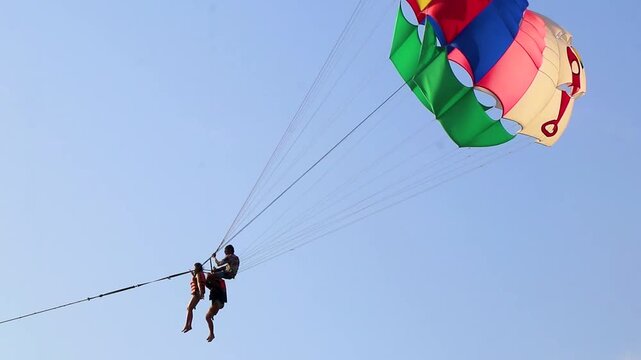 People tourism on parasailing parachute sport activity Patong Phuket Thailand.