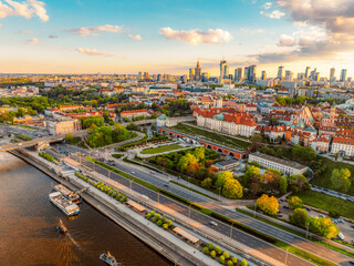 Fototapeta premium Warsaw old city center and skyscrapers in the background Vistula river. Sunset in Warsaw city center aerial view.