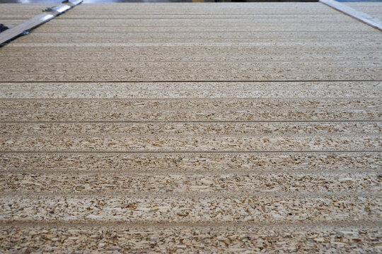 Stack of MDF wooden boards in furniture warehouse