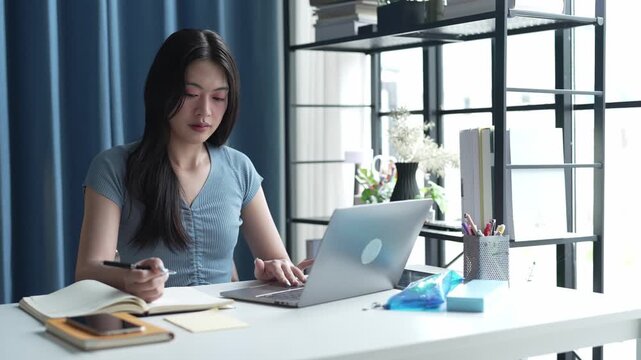 Asian Female University Student Studying Online on Laptop