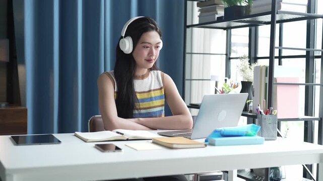 Asian Female University Student Studying Online on Laptop.
