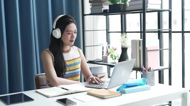 Asian Female University Student Studying Online on Laptop.