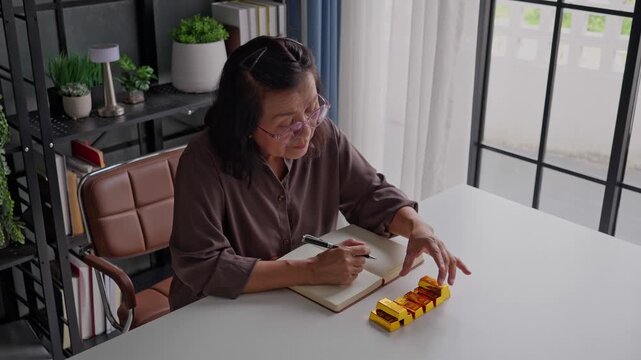 Elderly Asian woman plans retirement, invests in gold bars