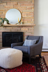 Fototapeta premium Living room with armchair, fireplace and patterned rug