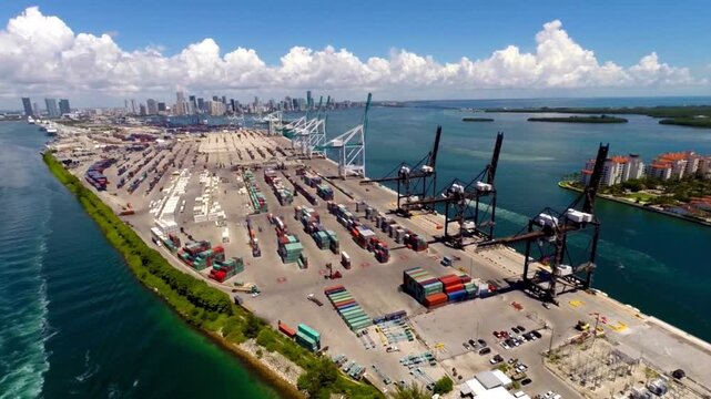 Aerial panorama of Port Miami cargo terminal and Miami city skyline. expansive container terminal, industrial gantry cranes, American maritime infrastructure, international trade logistics
