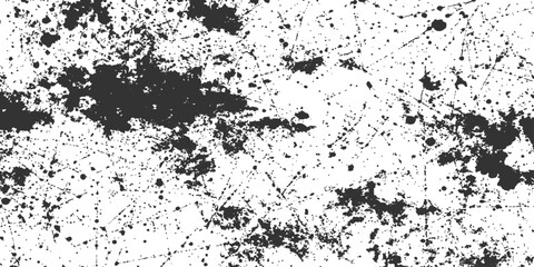 Fototapeta premium A striking monochromatic image of a textured surface, showcasing a random spray pattern. The contrast between dark ink splotches and a pristine background evokes a sense of artistic experimentation.