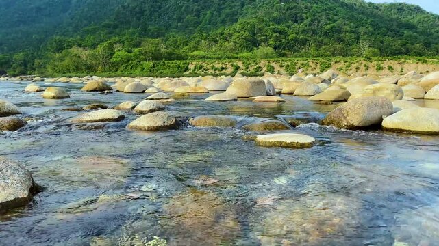 Scenic landscape view of Mountain to underwater River stream with rocks in sylhet, bangladesh.