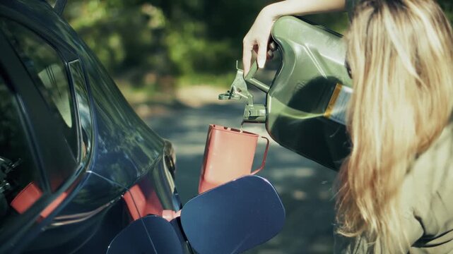 Driver Pouring Gasoline From Canister Into Car Fuel Tank. Refueling Vehicle On Roadside 