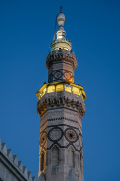 The Minaret of Qaytbay at the Umayyad Mosque in Damascus, illuminated at dusk. The minaret was built in the 15th century during the Mamluk period.