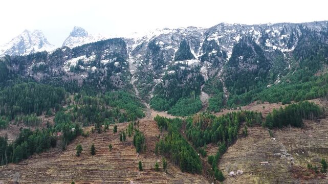 Drone view of Himalayan mountain range with snow peaks and forest landscape in Harsil Valley