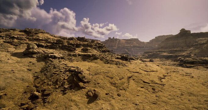 A vast desert stretches across the landscape, featuring rugged rock formations and soft sandy areas. The sky is adorned with scattered clouds, creating a serene atmosphere during sunset.