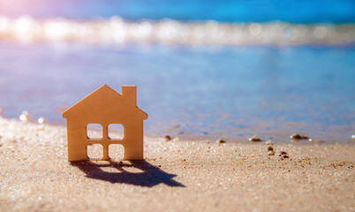 The symbol of the house standing on the seashore
